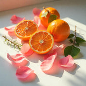 Mandarin and rose petals representing the olfactory notes of the perfume.